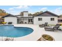 Inviting backyard featuring a private pool and lounge chairs on a spacious patio at 9235 Everwood St, Orlando, FL 32825