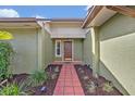 Close up of front door and brick path showcasing well maintained landscaping at 1002 Ohanlon Ct, Oviedo, FL 32765