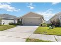 Single-story home featuring a two-car garage, a concrete driveway and well maintained yard at 1575 Eucalyptus Way, Davenport, FL 33837