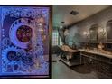 Unique steampunk themed bathroom featuring a clawfoot tub, custom lit partition, and vanity at 174 Yellow Snapdragon Dr, Davenport, FL 33837
