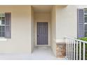 Close-up of the front door, showcasing its design and the stone accents on the porch at 1893 Rafton Rd, Apopka, FL 32703