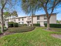 Condo exterior view featuring lush greenery and mature trees in a well-maintained community at 200 Maitland Ave # 228, Altamonte Springs, FL 32701