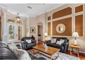 Well-lit Living Room featuring hardwood floors, crown molding, and lots of seating at 2008 Water Key Dr, Windermere, FL 34786