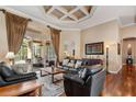 Spacious living room with hardwood floors, tray ceiling, large glass doors to outdoor space at 2008 Water Key Dr, Windermere, FL 34786