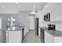 Modern kitchen with granite countertops, stainless steel appliances, and a large island at 2430 Park Ave, Indian Lake Estates, FL 33855