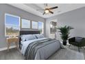 Serene main bedroom with large windows, a ceiling fan, and an ensuite bathroom at 2430 Park Ave, Indian Lake Estates, FL 33855