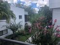 Exterior view showing mature landscaping and blossoming trees at 2597 Oak Park Way # 205, Orlando, FL 32822