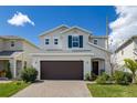 Beautiful two-story home featuring a two-car garage, brick driveway, and well-maintained landscaping at 2817 Noble Crow Dr, Kissimmee, FL 34744