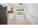 Open dining area with access to the backyard and a view of the kitchen at 2900 E Grant Ave, Orlando, FL 32806