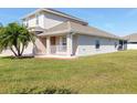 Lovely home showcasing a green lawn, a side porch, and a well-maintained exterior at 3006 Mandolin Dr, Kissimmee, FL 34744