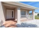 Inviting front porch with white railings, brick flooring, and a well-lit entryway at 3006 Mandolin Dr, Kissimmee, FL 34744