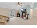 Bright living room featuring a ceiling fan, fireplace, and large TV at 344 Sandpiper Dr, Casselberry, FL 32707