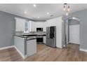 Modern kitchen featuring white cabinets, stainless steel appliances, and stone countertops at 352 Misty Oaks Run, Casselberry, FL 32707