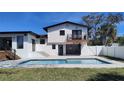 View of the pool and house, with a small balcony and backyard space at 382 Riverside Dr, Ormond Beach, FL 32176