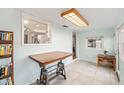 Entryway with tile flooring leading to kitchen, featuring an adjustable table desk at 430 E Crystal Lake St, Orlando, FL 32806