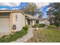 Lovely home with well-maintained landscaping, walkway, and an attached two-car garage at 545 Ne 45Th Ct, Ocala, FL 34470