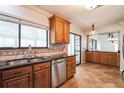Well-lit kitchen featuring wood cabinets, stainless steel appliances, granite countertops and tile flooring at 545 Ne 45Th Ct, Ocala, FL 34470