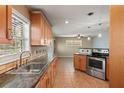 Bright eat-in kitchen featuring tile floors, stainless appliances and plenty of cabinet space at 6331 Lake Lerla Dr, Apopka, FL 32712