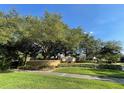 Well maintained community sign surrounded by landscaping, with inviting curb appeal at 6451 Old Park Ln # 302, Orlando, FL 32835