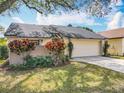 Single-story home with a two-car garage, mature landscaping, and well-maintained lawn, enhancing its appeal at 734 Adidas Rd, Winter Springs, FL 32708