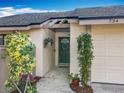 Inviting front entrance with lush greenery and stylish accents, enhancing the home's welcoming appeal at 734 Adidas Rd, Winter Springs, FL 32708