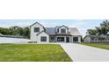 Charming two-story modern farmhouse with black trim and a sprawling green lawn at 1070 Lake Ariana Blvd, Auburndale, FL 33823