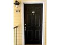 A solid black front door, with an ADT security system, and black hardware provides a secure entry at 1081 S Hiawassee Rd # 723, Orlando, FL 32835