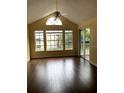 Bright living room with vaulted ceiling, lots of windows, and sliding door to balcony at 1081 S Hiawassee Rd # 723, Orlando, FL 32835