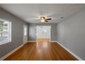 Bright and airy living room with gleaming hardwood floors and fresh paint, connecting seamlessly to other living spaces at 1111 Guernsey St, Orlando, FL 32804