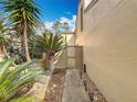 Side yard with mature landscaping, privacy gate and stone path to the entrance of the property at 117 Starling Ln, Longwood, FL 32779