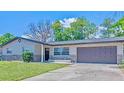 Charming single-story home with a well-manicured lawn and a two-car garage at 1420 Continental Dr, Daytona Beach, FL 32117
