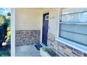 Close-up of the front door with stone accents and decorative address numbers at 1420 Continental Dr, Daytona Beach, FL 32117