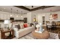 Cozy living room featuring a white sofa, dining space, and direct access to the modern kitchen at 145 Old Moss Cir, Deland, FL 32724