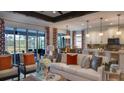 Spacious living room showcasing an open floor plan with a stylish sofa and direct access to the kitchen and patio at 145 Old Moss Cir, Deland, FL 32724