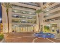 The Vue lobby entrance with covered parking, elegant fountain, and paver walkway at 150 E Robinson St # 2308, Orlando, FL 32801