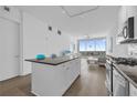 Modern kitchen featuring island, stainless appliances, and open layout flowing into the living area with skyline views at 150 E Robinson St # 2308, Orlando, FL 32801