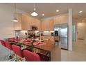 Well-equipped kitchen with stainless steel appliances, granite countertops, and a breakfast bar with seating at 1523 Still Dr, Clermont, FL 34714