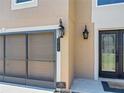 Close-up of home exterior with lantern-style lighting, double-door entrance, and clear house number at 1705 Ridgemoor Dr, Mascotte, FL 34753
