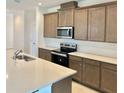 Beautiful kitchen featuring stainless steel appliances, lots of cabinets, and a large island for meal preparation at 1988 Iorio Dr, St Cloud, FL 34771