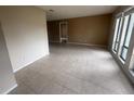 Spacious living room with tile flooring and natural light from the windows at 204 W Cottesmore Cir, Longwood, FL 32779
