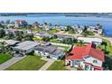 An aerial view of single-story home showcasing its location in a waterfront residential neighborhood at 3226 S Peninsula Dr, Daytona Beach Shores, FL 32118
