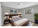 Comfortable bedroom with a large bed, natural light from a window, and modern decor at 4112 Grove Pl, Lakeland, FL 33810