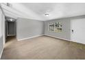 Bright living room with carpeted floors and a view to the front yard at 4112 Grove Pl, Lakeland, FL 33810