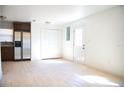 Kitchenette with tile floors, stainless fridge, wood cabinets, and closet at 4840 Transport Rd, Bartow, FL 33830
