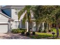 Charming two-story home with manicured landscaping and a beautiful paver driveway at 5006 Legacy Oaks Dr, Orlando, FL 32839