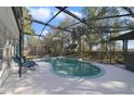Backyard pool featuring a screened enclosure and lounge chairs, perfect for relaxing and enjoying the outdoors at 5317 Montford Pl, Apopka, FL 32712