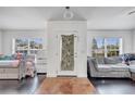 Open-concept room featuring dark wood floors and plenty of natural light at 639 Mesilla Dr, Kissimmee, FL 34758