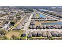 An aerial view of a neighborhood featuring many two-story homes and community ponds at 869 Rivers Crossing St, Clermont, FL 34714