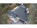 Aerial view of a gray roof on a home, featuring solar panels and seamless gutters at 1102 Hamlin Ave, Howey In The Hills, FL 34737