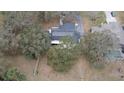 High angle aerial view of home featuring solar panels and lush green landscaping at 1102 Hamlin Ave, Howey In The Hills, FL 34737